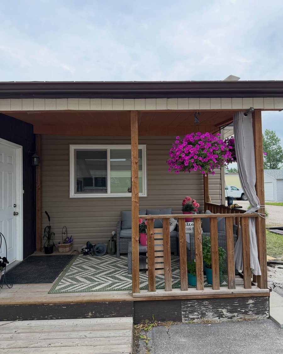 A covered porch with timber posts and a finished railing.