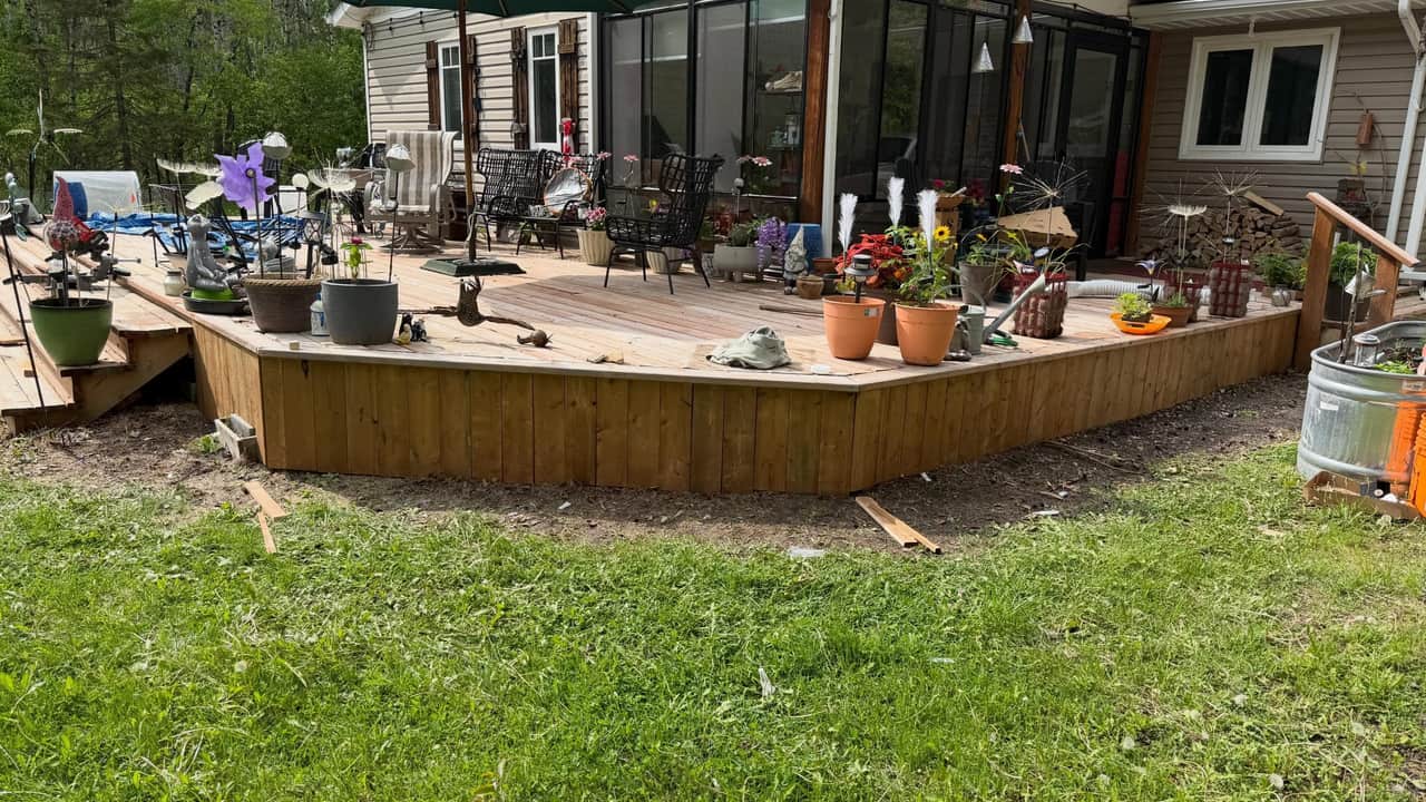 A rebuilt wrap-around deck with fresh cedar skirting running the length of the house.